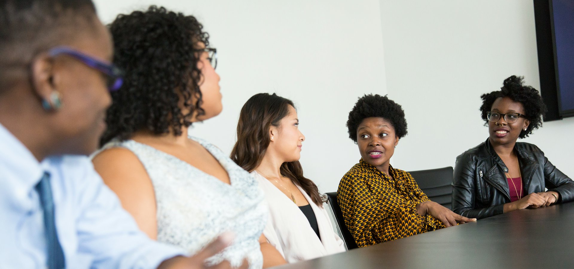 A diverse team in discussion around a conference table