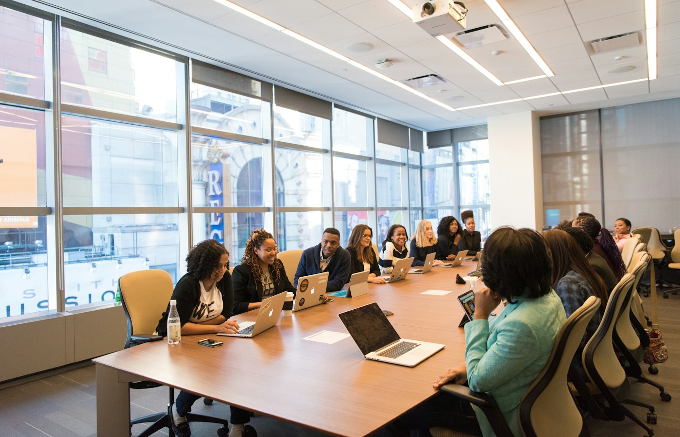 A group of professionals in a working session around a long table